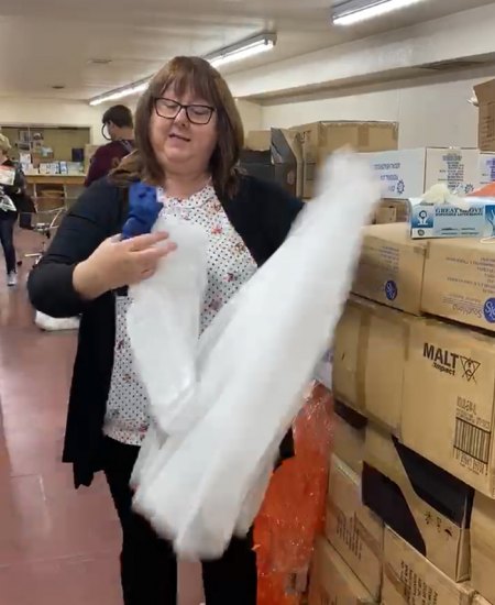 Tammy Gonzales, Director of Materials Management, checks out boxes of PPE shipped by World Vision to Hanford Adventist Health.